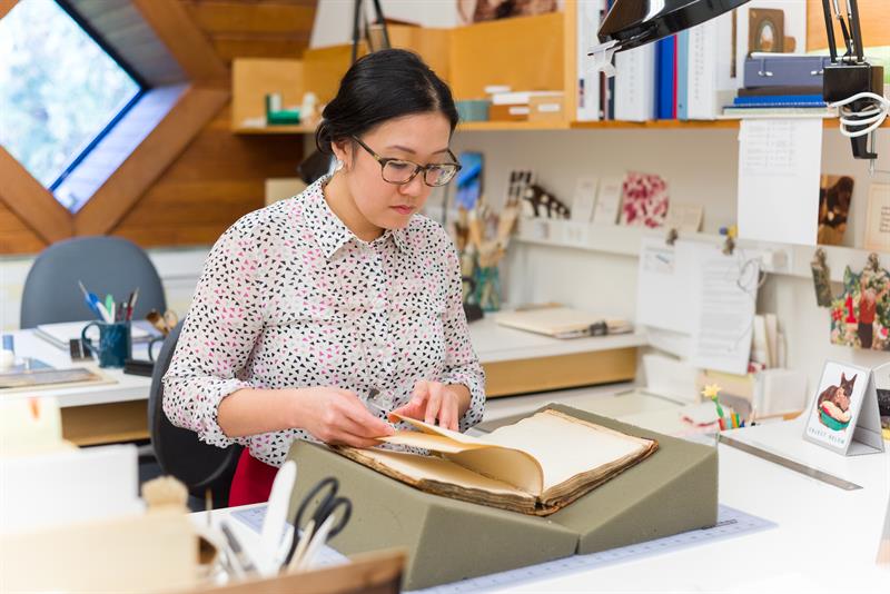 Victoria Wong examines a book