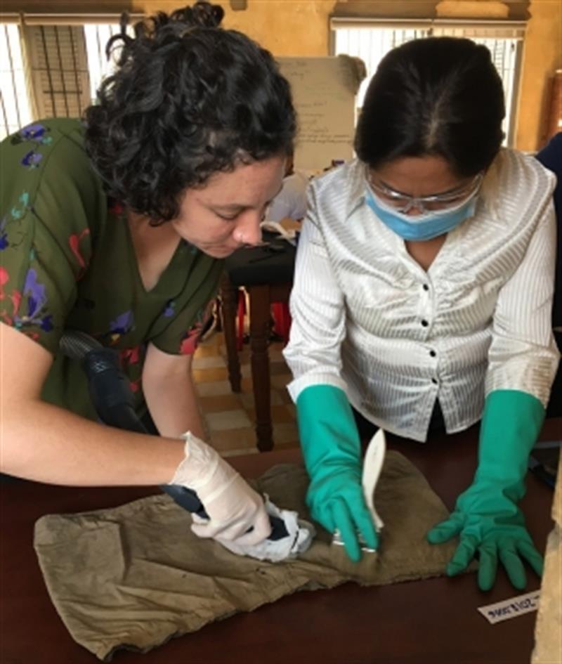 Conservators clean a pair of shorts