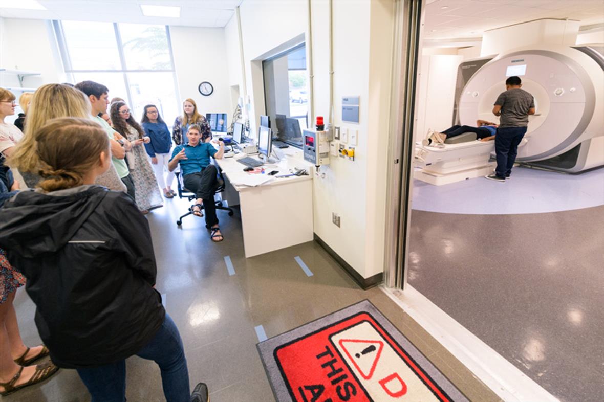 Students look at MRI machine