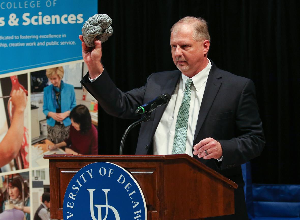 John Pelesko holds a model of a brain