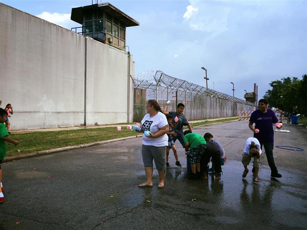 Adults and children outside the jail
