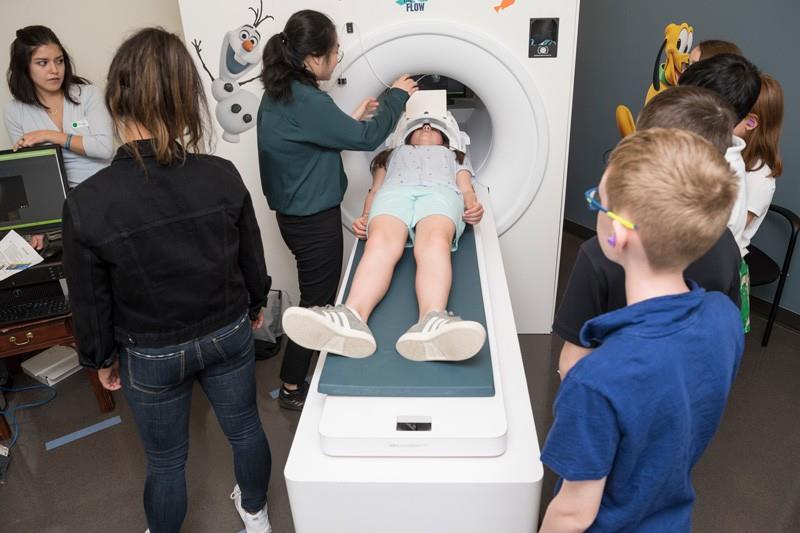 Students try out a mock MRI scanner