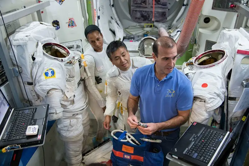Astronauts Rick Mastracchio (right) and Koichi Wakata (center) join Jeanette Epps in a planning and preparation session in an International Space Station mock-up/trainer in the Space Vehicle Mock-up Facility at NASA's Johnson Space Center.