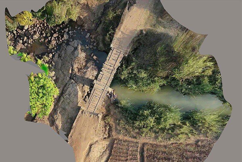This aerial shot of a bridge in Malawi, Africa, shows problems with the planks and a significant need for repair. The Engineers Without Borders chapter at the University of Delaware is partnering with the community to study the integrity of the bridge and develop repair options. Civil engineering major Drew Huffer is the project manager.