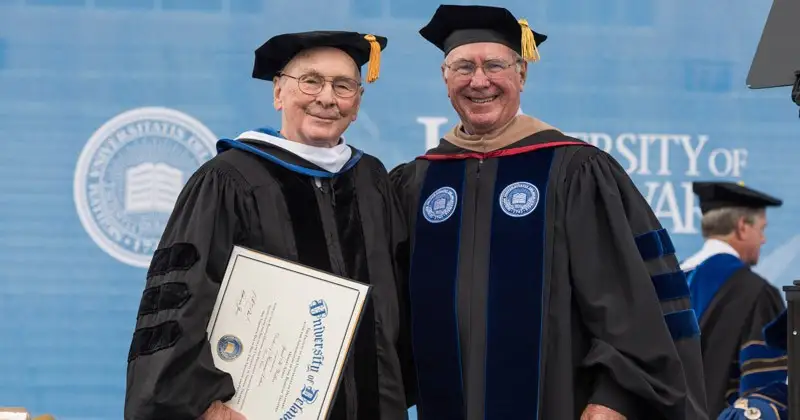 At the 2015 UD Commencement ceremony, Jewel Walker (left) is presented an honorary doctor of humane letters degree by Gil Sparks, then-chairman of the Board of Trustees.