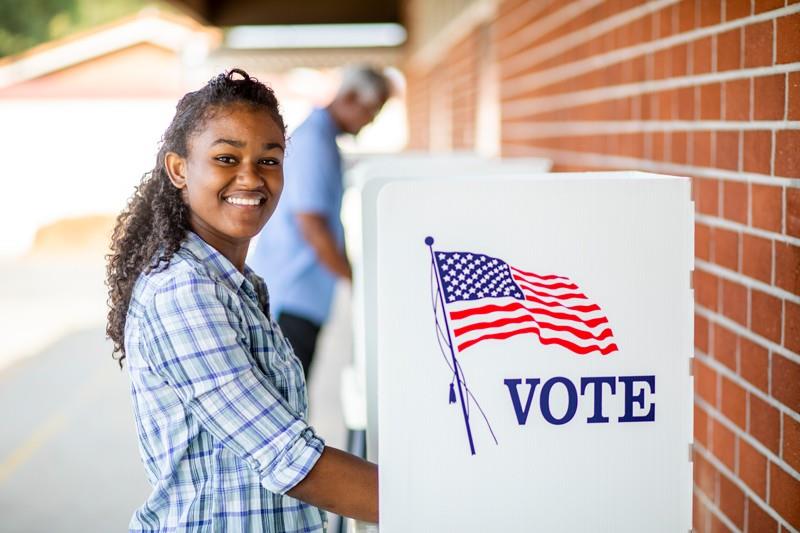 Young woman at voting machine