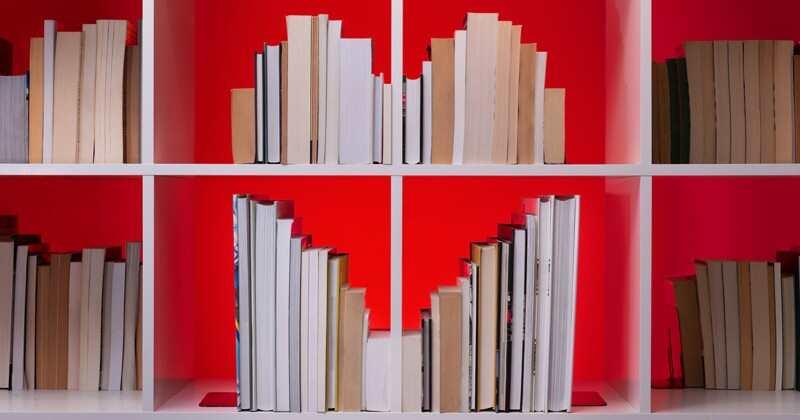 shelf of books arranged in heart shape