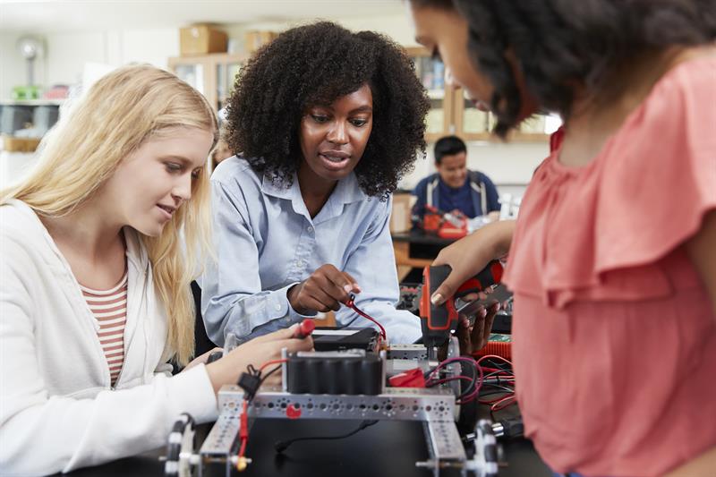 Female Teacher with female students Building Robotic Vehicle In Science Lesson
