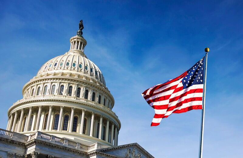 American flag flies in front of the Capitol Building