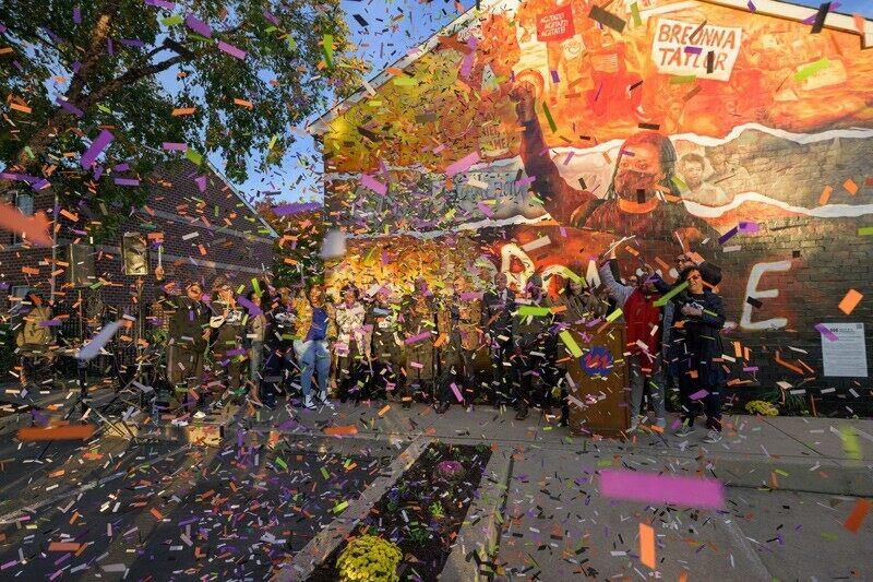 confetti in the air in front of a mural