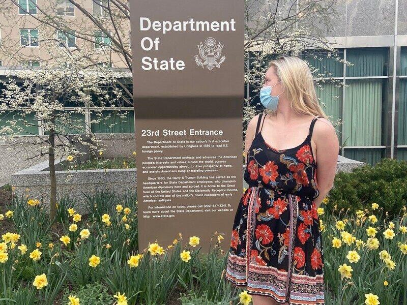 Student outside State Department office building