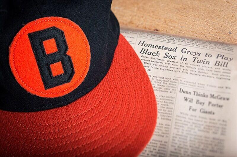 Photo of Black Sox cap and old newspaper