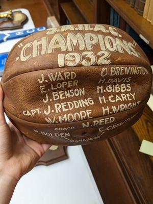 hand holding old football 