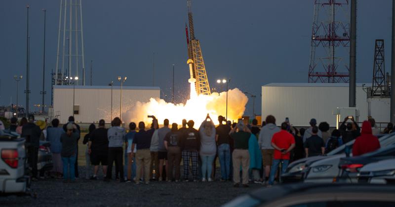 Group of people watching rocket launch