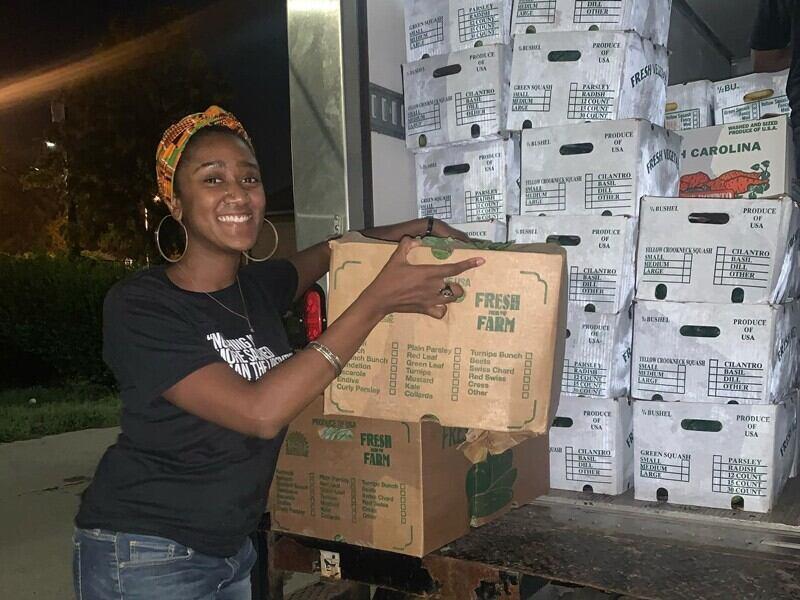 woman with boxes of produce