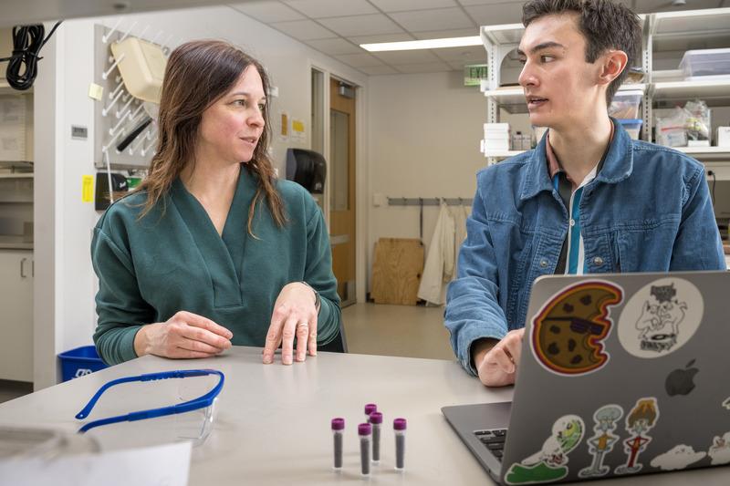 ​Tara Trammel and Wu examining data in lab
