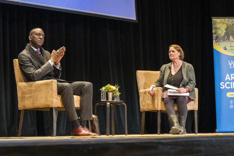 Yusef Salaam and Angela Hattery talking on stage.
