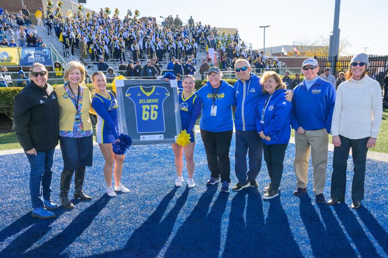 Sarver, UD President Dennis Assanis, and UD First Lady along with others taking picture during football game