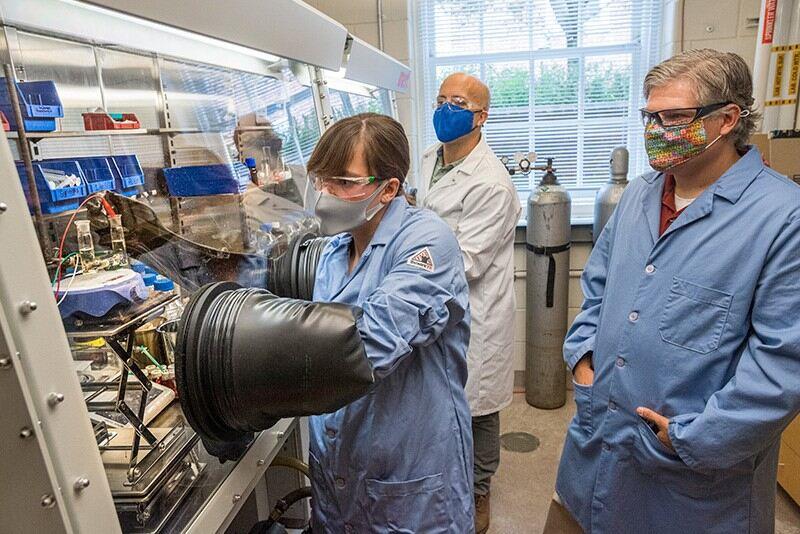 Three researchers working in lab